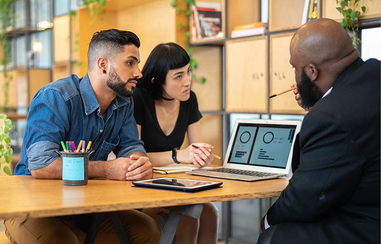 Couple evaluating their debt with a financial advisor